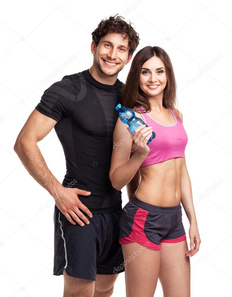 Athletic man and woman with bottle of water on the white