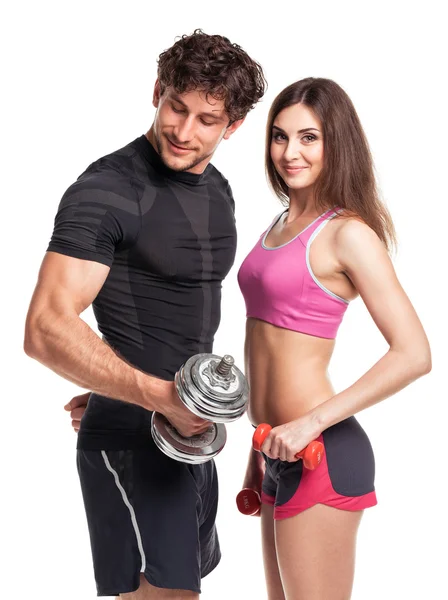 Athletischer Mann und Frau mit Hanteln auf weißem Hintergrund — Stockfoto