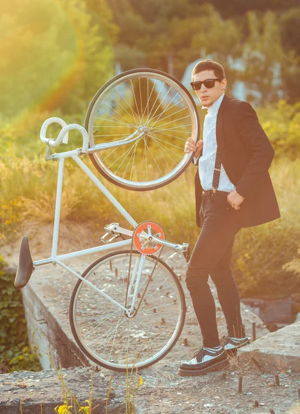 Young stylish guy with bicycle outdoors — Stock Photo, Image