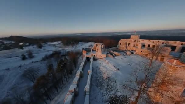 Aerial view of beautiful historic castle ruins on the hill in winter at sunset. Tenczyn Castle, Poland. Filmed on FPV drone. — Stock Video