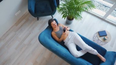 Kablosuz kulaklık takan, müzik dinleyen, mobil uygulama kullanan ya da sosyal ağlarda akıllı telefondan iletişim kuran bir kadın.
