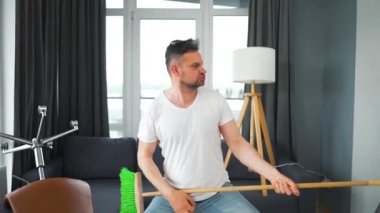 Adam temizlik yapıyor ve kendini rock yıldızı olarak hayal ediyor. Süpürgeyi gitar gibi çalıyor. Yavaş çekim