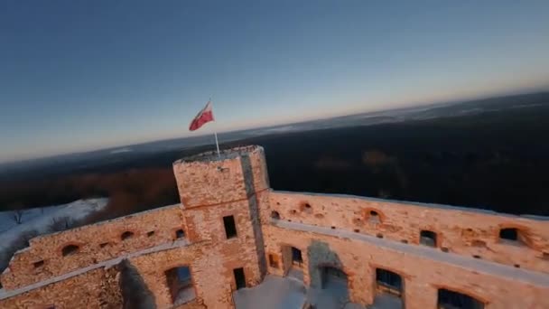 Vista aérea das ruínas históricas bonitas do castelo na colina no inverno no por do sol. Castelo de Tenczyn, Polónia. Filmado em drone FPV. — Vídeo de Stock