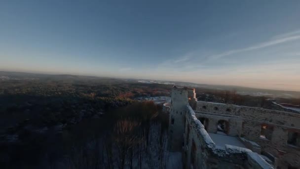 Aerial view of beautiful historic castle ruins on the hill in winter at sunset. Tenczyn Castle, Poland. Filmed on FPV drone. — Stock Video