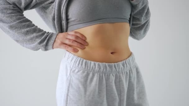 Woman compressing the skin on her stomach checking for excess subcutaneous fat — Stock Video