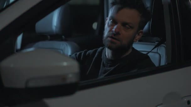 Чоловік сідає в машину, засмучений тим, що його зупинила поліція за порушення правил дорожнього руху. — стокове відео