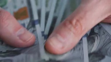Amerikan dolarlarını sayan ya da nakit ödeyen eller. Yatırım, başarı, finansal beklentiler veya kariyer ilerlemesi kavramı