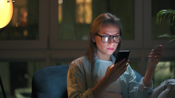 Woman Glasses Sitting Armchair Using Smartphone Night Night Concept Remote — Stock Video