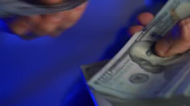 男性の手は 警察の車のライトを背景に米ドル紙幣をチェックするか 現金で計算します 金融犯罪の概念 動画クリップ