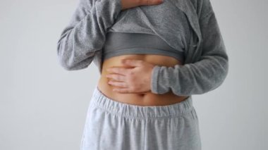 Kadın derisini karnına ve yanlarına bastırıp deri altında fazla yağ var mı diye kontrol ediyor. Genel kabul görmüş güzellik standartlarını karşılamaya çalışma kavramı