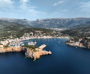 Majorca, Spain. Aerial view of summer resort town Port de Soller on Mallorca (Majorca) island, marina, sandy beach, boats, yachts, clear waters of Mediterranean Sea - landscape of Balearic Islands from above, Europe.