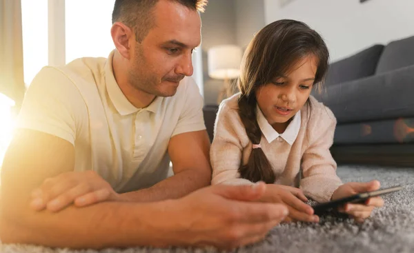 Father Daughter Enjoying Time Together Using Tablet Family Entertainment While Stock Picture
