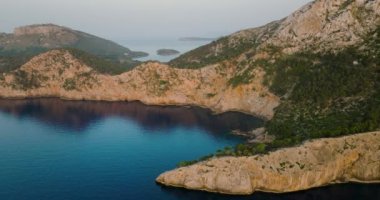 Scenic aerial view of a mountainous region in Majorca with cliffs. Panoramic view of Mirador Es Colomer in Sierra de Tramuntana and blue sea, Balearic Islands, Spain.
