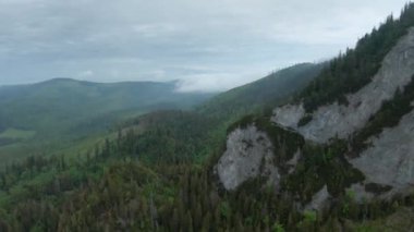 Aerial view of a summer rocky mountain landscape. Flying through the clouds, close to the mountains. High Tatras, Slovakia