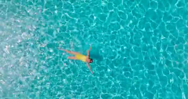 Top View Woman Yellow Swimsuit Lying Her Back Pool Relaxing — Stock video