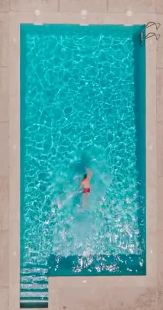 Vertical Video Aerial View Man Red Shorts Swimming Pool Summer — Vídeos de Stock