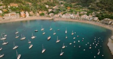 Majorca, Spain. Aerial view of summer resort town Port de Soller on Mallorca Majorca island, sandy beach, boats, yachts, clear waters of Mediterranean Sea - landscape of Balearic Islands from above