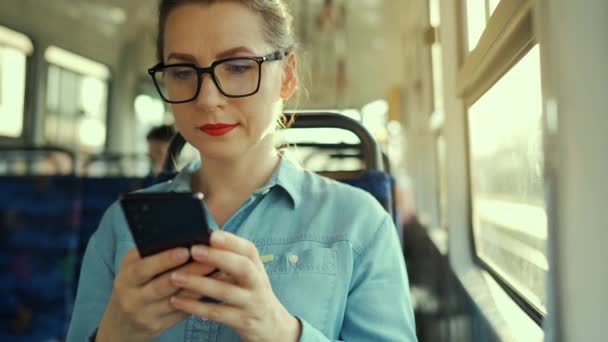 Public Transport Slow Motion Woman Glasses Tram Using Smartphone Chatting — Vídeo de stock