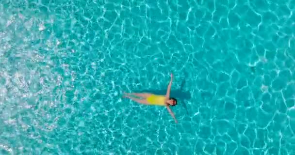 Top View Woman Yellow Swimsuit Lying Her Back Pool Relaxing — 图库视频影像