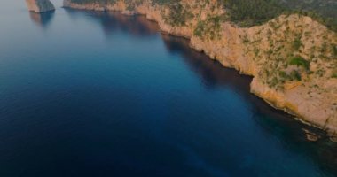Scenic aerial view of a mountainous region in Majorca with cliffs. Panoramic view of Mirador Es Colomer in Sierra de Tramuntana and blue sea, Balearic Islands, Spain.