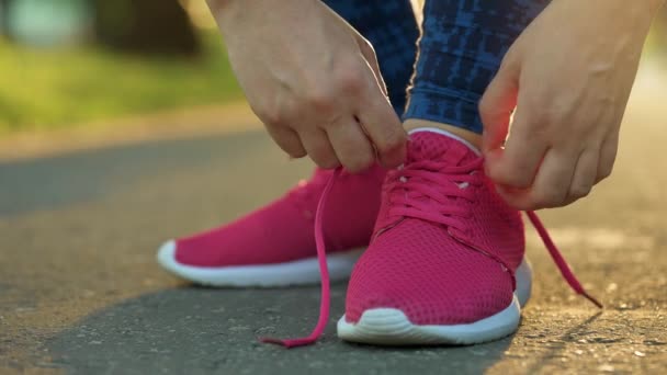 Woman Tying Shoelaces While Jogging Walking Sunset Close Slow Motion — Stock Video