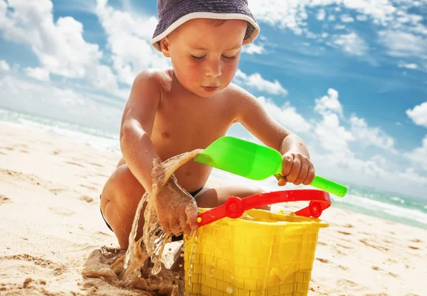 Small boy playing with toys on the beach — Stock Photo, Image