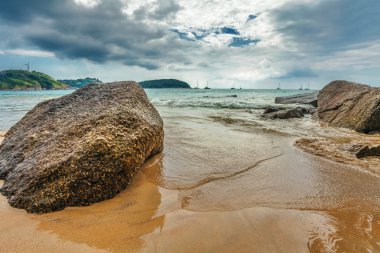 karanlık gökyüzü altında tropik sahil