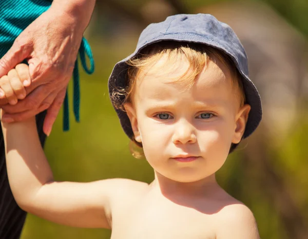 Grandmother holding grandson's hand — Stock Photo, Image