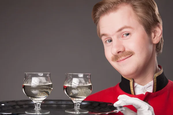 Smiling Waiter in red uniform — Stock Photo, Image