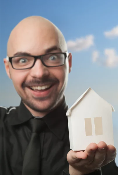 Man holding a paper house. — Stock Photo, Image