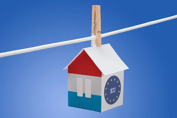 Luxembourg and EU flag on paper house — Stock Photo, Image