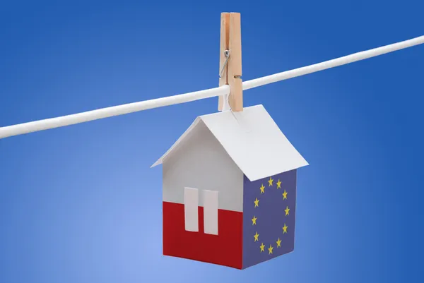 Poland, polish and EU flag on paper house Stock Picture