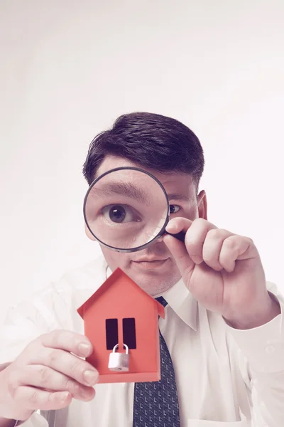 Man with magnifying glass house and paper — Stock Photo, Image