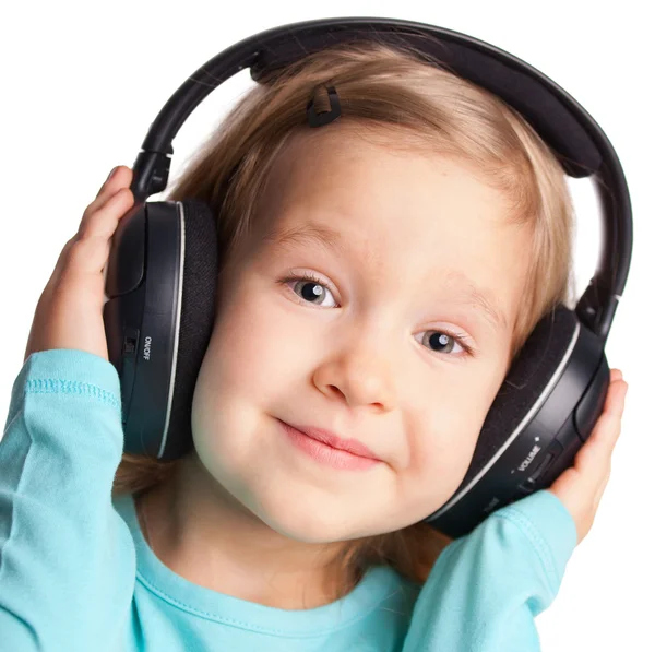 Little girl in headphones Stock Image