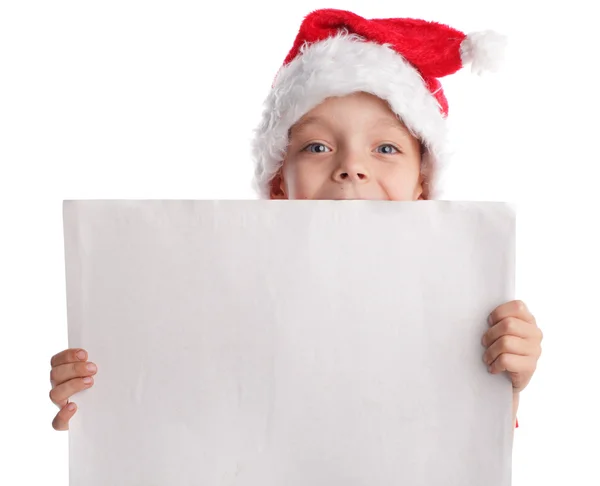 Ребенок в рождественской шляпе и форма в руках — стоковое фото