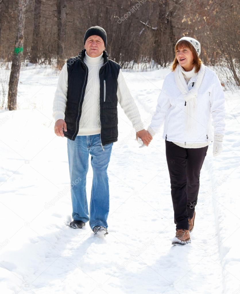 Seniors couple in winter park