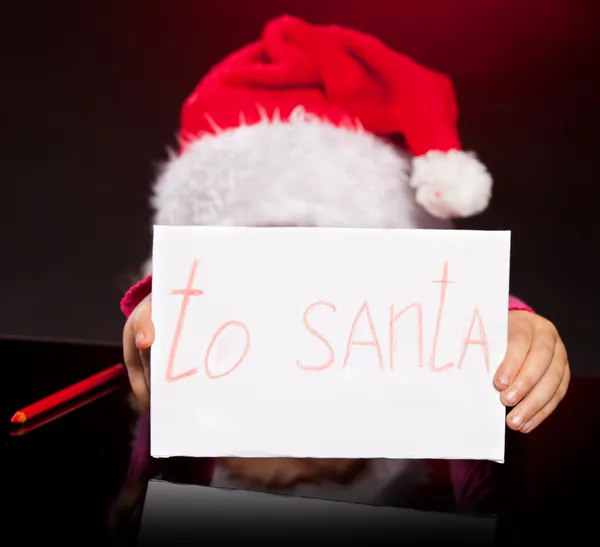 Girl writing a letter to santa claus — Stock Photo, Image