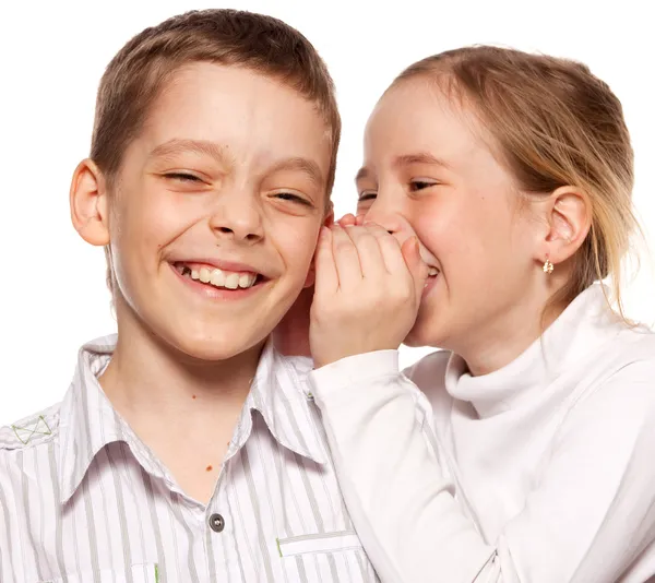 Girl whispers boy in the ear secret — Stock Photo, Image