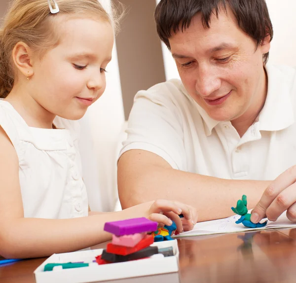 Tjej och pappa gjuten från lera leksaker — Stockfoto