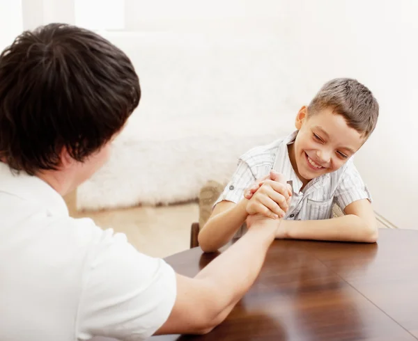 Father and son arm wrestling — Stock Photo, Image