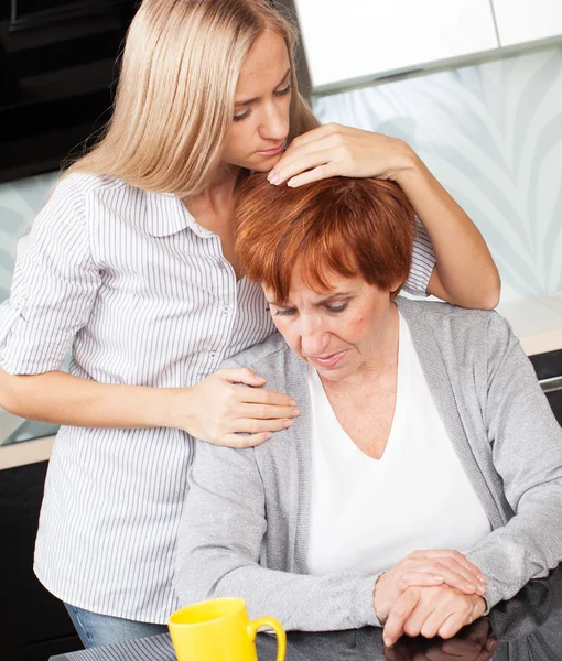 Daughter soothes sad mother — Stock Photo, Image