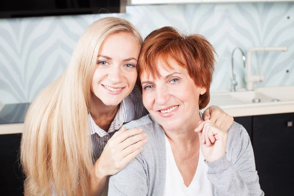 Kvinna med dotter på kök — Stockfoto