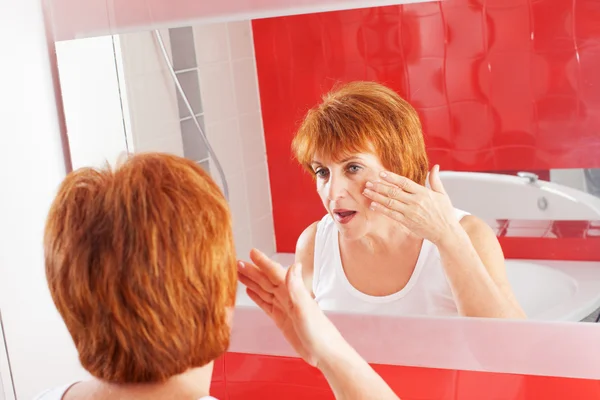 Woman gets cream on face — Stock Photo, Image