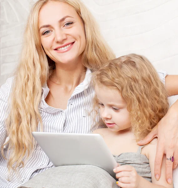 Mother and daughter wiht tablet at sofa — Stock Photo, Image