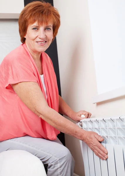 Mujer controla la temperatura del radiador — Foto de Stock