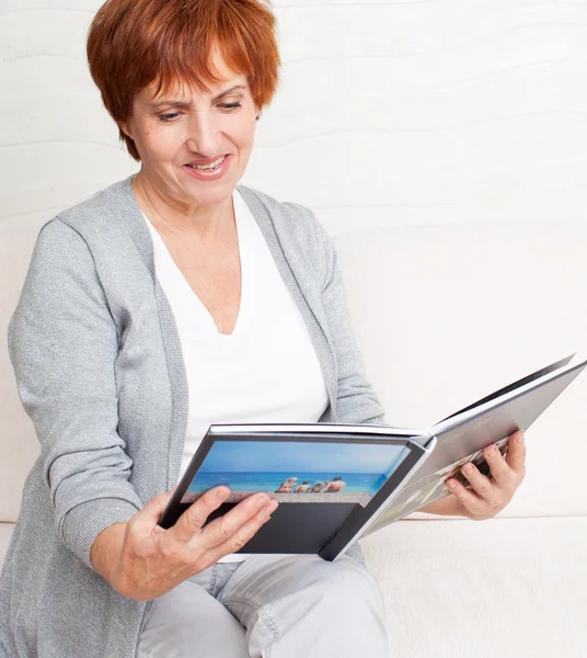 Woman looking photo book — Stock Photo, Image