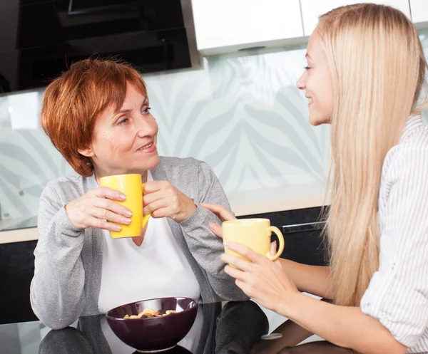 Mujer con hija en la cocina — Foto de Stock