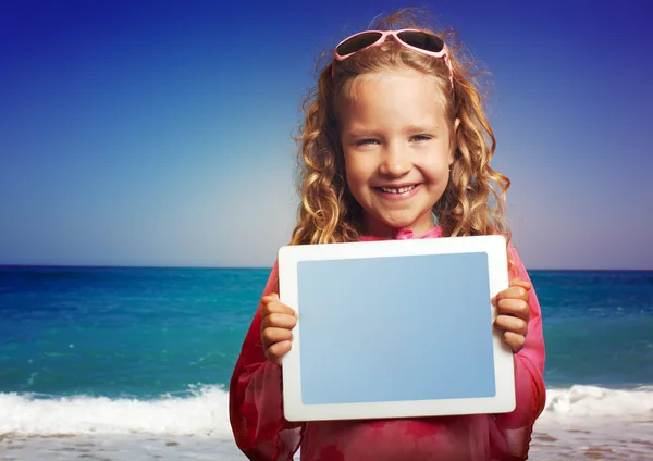 Kind op het strand met tablet pc — Stockfoto