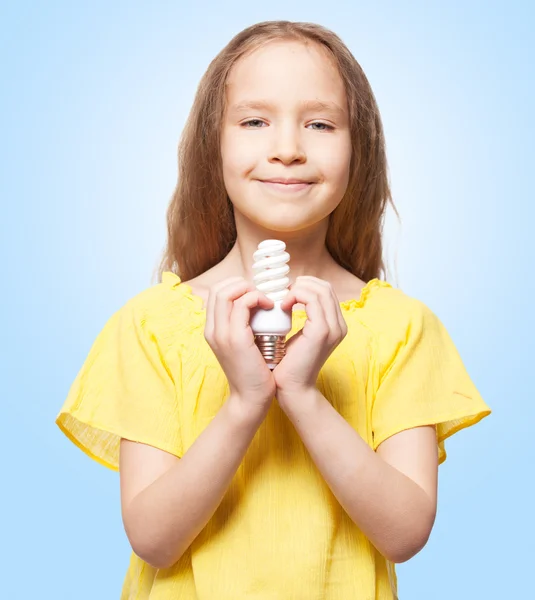 Ragazza in possesso di una lampada a risparmio energetico — Foto Stock