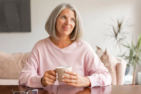 Happy Mature Woman Resting Table Drink Coffee Tea Looking Away — Stock Photo, Image